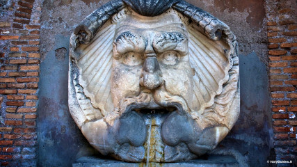 Aventine: Fountain with large mask outside of the Orange garden